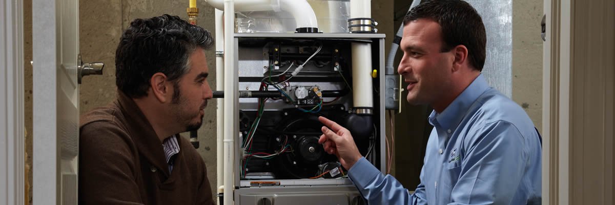 Hvac Tech Explaining The Trane Furnace To Homeowner